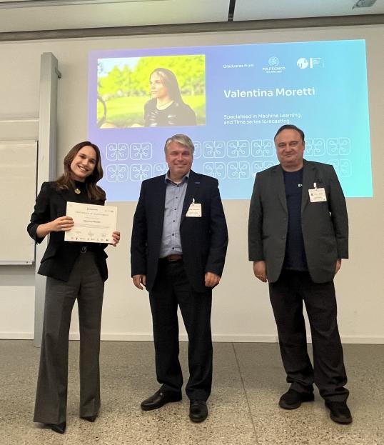 Picture of Valentina holding here certificate with Anders Dam Jensen, the Executive Director for the European High Performance Computing Joint Undertaking and another person